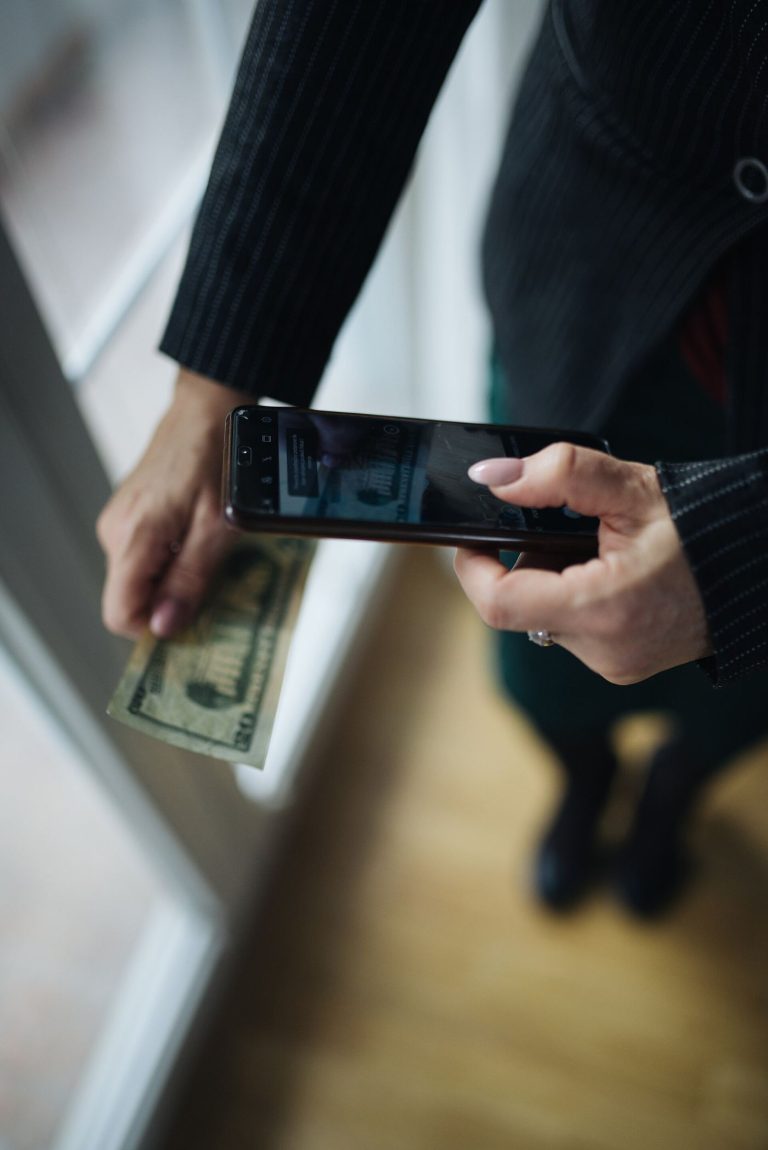 Payment Firms Test Crypto Rails for Business Transfers paying for goods with a smartphone