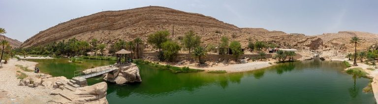 Arid mountains and desert plain in Oman under a clear sky